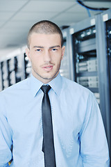 Image showing young it engeneer in datacenter server room