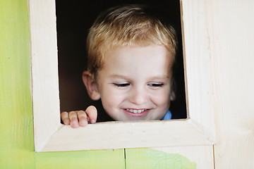 Image showing happy child in a window