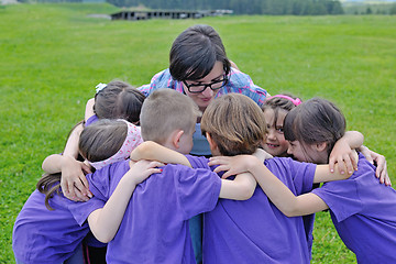 Image showing happy kids group with teacher in nature