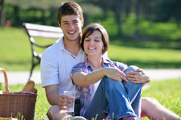 Image showing happy young couple having a picnic outdoor