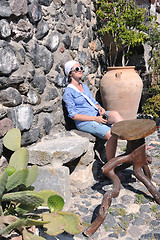 Image showing Greek woman on the streets of Oia, Santorini, Greece