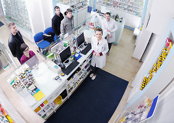 Image showing pharmacist suggesting medical drug to buyer in pharmacy drugstor