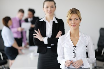 Image showing business woman standing with her staff in background