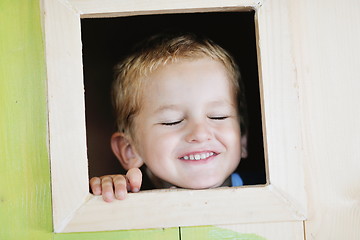 Image showing happy child in a window