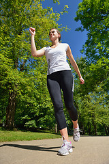 Image showing Young beautiful  woman jogging at morning in park