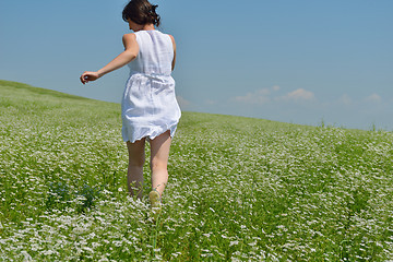 Image showing Young happy woman in green field