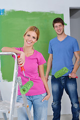 Image showing happy couple paint wall at new home