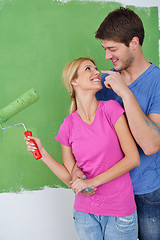 Image showing happy couple paint wall at new home