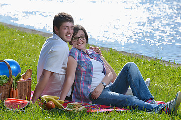 Image showing happy young couple having a picnic outdoor