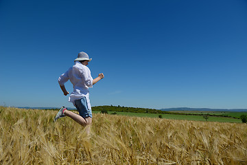 Image showing young woman in wheat field at summer