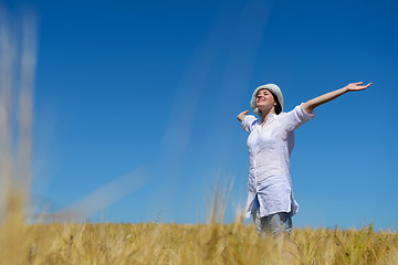 Image showing young woman in wheat field at summer