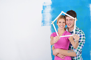 Image showing happy couple paint wall at new home