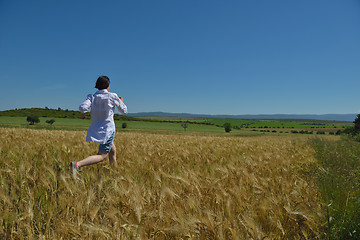 Image showing young woman in wheat field at summer