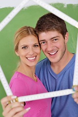 Image showing happy couple paint wall at new home