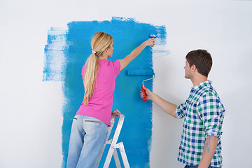 Image showing happy couple paint wall at new home