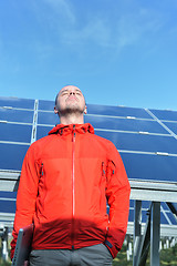 Image showing engineer using laptop at solar panels plant field