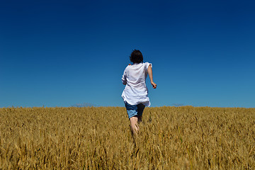 Image showing young woman in wheat field at summer