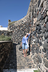 Image showing Greek woman on the streets of Oia, Santorini, Greece