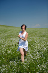 Image showing Young happy woman in green field