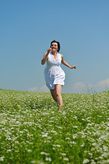 Image showing Young happy woman in green field