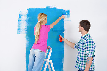 Image showing happy couple paint wall at new home