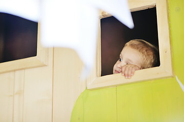 Image showing happy child in a window
