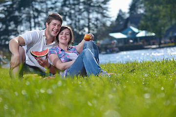 Image showing happy young couple having a picnic outdoor