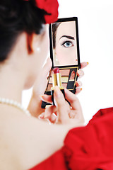 Image showing beautiful young woman applying makeup