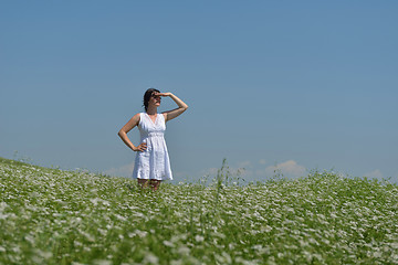 Image showing Young happy woman in green field