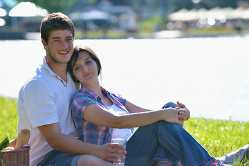 Image showing happy young couple having a picnic outdoor