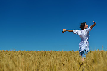 Image showing young woman in wheat field at summer