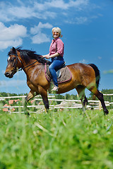Image showing happy woman  ride  horse