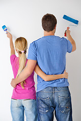 Image showing happy couple paint wall at new home