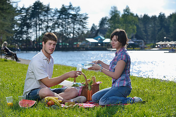 Image showing happy young couple having a picnic outdoor