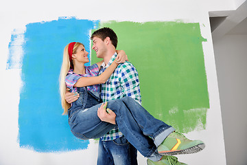 Image showing happy couple paint wall at new home