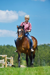 Image showing happy woman  ride  horse