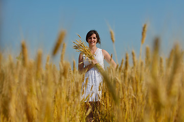 Image showing young woman in wheat field at summer