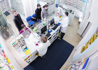 Image showing pharmacist suggesting medical drug to buyer in pharmacy drugstor