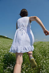 Image showing Young happy woman in green field