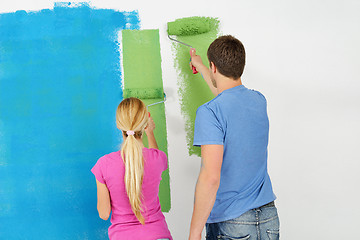 Image showing happy couple paint wall at new home