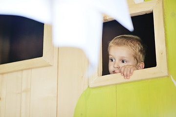 Image showing happy child in a window