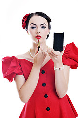 Image showing beautiful young woman applying makeup