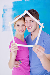 Image showing happy couple paint wall at new home