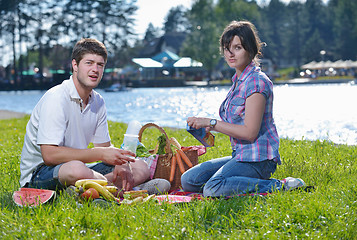 Image showing happy young couple having a picnic outdoor