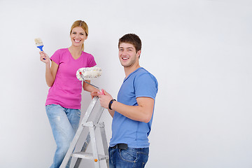 Image showing happy couple paint wall at new home