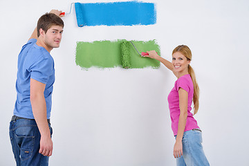 Image showing happy couple paint wall at new home