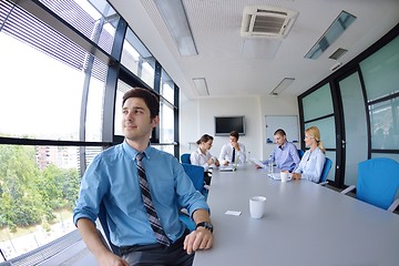 Image showing business man  on a meeting in offce with colleagues in backgroun