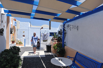 Image showing Greek woman on the streets of Oia, Santorini, Greece