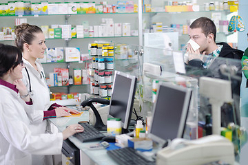 Image showing pharmacist suggesting medical drug to buyer in pharmacy drugstor