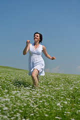 Image showing Young happy woman in green field